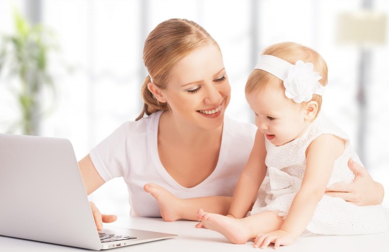 mother and baby at home using laptop computer